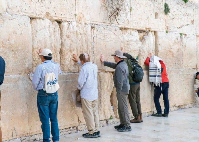 praying at western wall jerusalem pilgrimage tour holy land