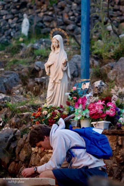 mary with praying at the blue cross medjugorje pilgrimage and rome pilgrimage catholic journeys